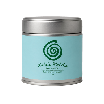 A silver metal canister of Lala's Matcha Tokimidori single-leaf ceremonial matcha, featuring a light blue label with a green spiral logo, set against a plain white background.